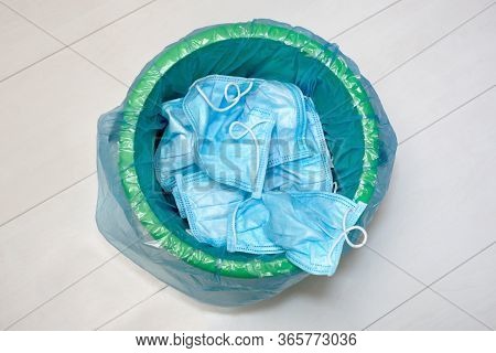Used Protective Masks. Trowing Facemask Into The Bin. Utilization Of Protection During. The End Of P