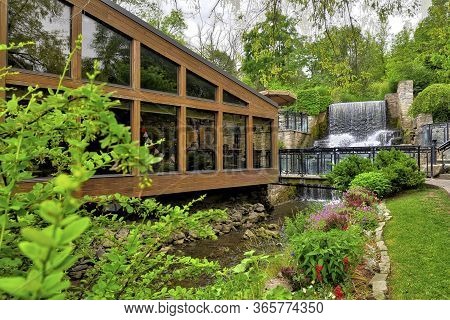 Ancaster Mill With A Waterfalls In The Background.