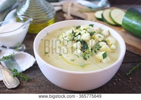 Zucchini Vegretable Cream Soup, Thyme And Olive Oil Dressing On Wooden Background. Rustic Style