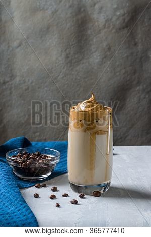 Cold Trendy Drink Of Korean Dalgon Coffee On A Dark Background. Delicious And Popular Coffee In Tren