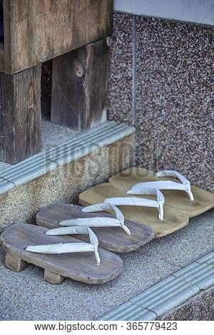 Japanese Culture. Two Pairs Of Traditional Japanese Sabot Sandals Near The Shrine Entrance On Mount 