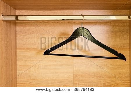Single Empty Black Clothing Rack Hanging On Coathanger In Closet With Copy Space