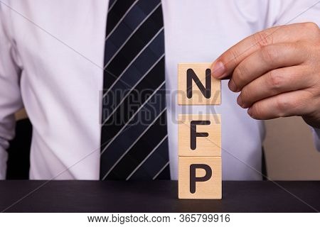 Man Made Word, Text Business Acronym Nfp As Not For Profit With Wood Blocks. Concept.