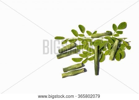 Moringa Oleifera Or Drumstick Pods And Leaves Isolated On White Background In Horizontal Orientation