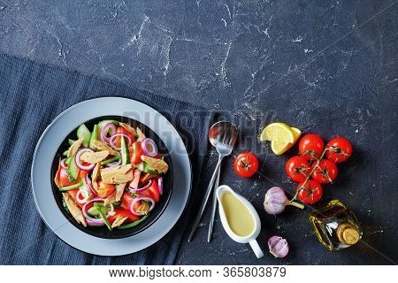 Low-carb Green Bean, Cucumber And Canned Tuna Salad With Tomatoes And Red Onion On A Black Plate On 