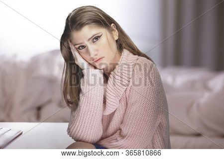Lonely Woman At Home During A Pandemic Lockdown Or Quarantine Feeling Despair And Sadness Because Of