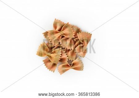 Heap Of Italian Raw Dry Pasta Farfelle With Tomatoes And Basil Isolated On White Background. Top Vie