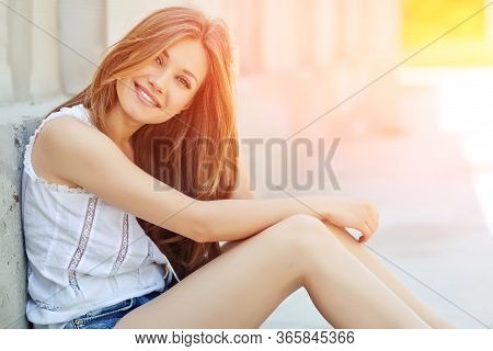 Beautiful Woman. Young Girl With Rays Of Sunset Bill. Portrait.