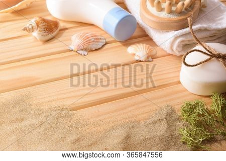 Thalassotherapy Products For Body Treatment On Wooden Slats Table Decorated With Seaweed Shells And 