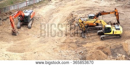 Excavator Working To Get Rid Of The Rubbish In A Demolition Site. Demolition Of The Old Industrial B