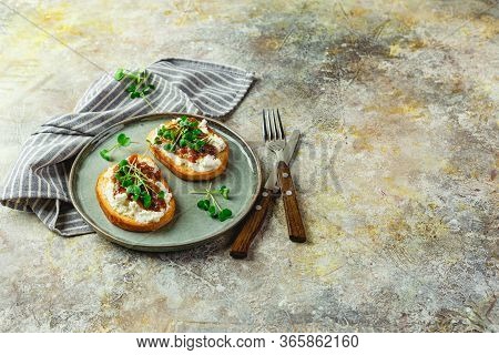 Canape Or Crostini With Toasted Baguette, Cottage Cheese, Fig Jam And Microgreen On Plate. Delicious