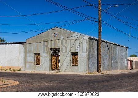 Old Abandoned Corner Building With Wrought Iron Windows & Door