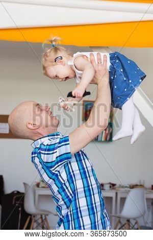 Hearing Aid In Baby Girls Ear. Toddler Child Wearing A Hearing Aid At Home. Disabled Child, Disabili
