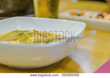 White Plate Of Bean Stew. Home-cooked Food. Accompanied By Cold Beer. Restaurant Menu Of The Day