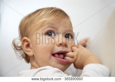 Cute Baby Girl With Blond Hair Close Up With Neautiful Expression