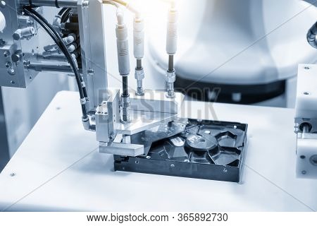 The Robotic Arm Picking Up The Circuit Board Parts Assembly In The Hard Disk Part. The Hi-technology