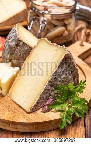 Pieces Of Cheese Tomme De Montagne Or Tomme De Savoie Made From Cow Milk In French Alps.