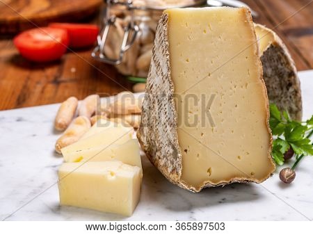 Pieces Of Cheese Tomme De Montagne Or Tomme De Savoie Made From Cow Milk In French Alps.