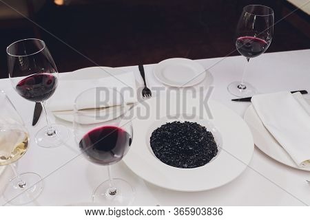 Delicious Italian Risotto With Cuttlefish Ink Squid-ink . Black Risotto. Healthy Tasty Food.