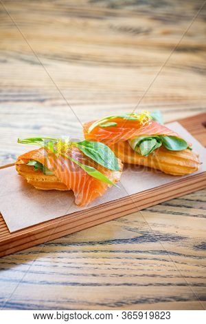Salty Ecler With Fresh Salmon On Top And Cheese