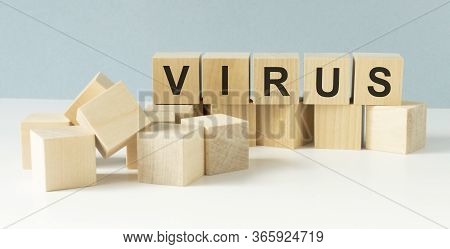 The Inscription Corona Virus On A Wooden Background, Top View. The Epidemic Of The Covid-19 Virus. W