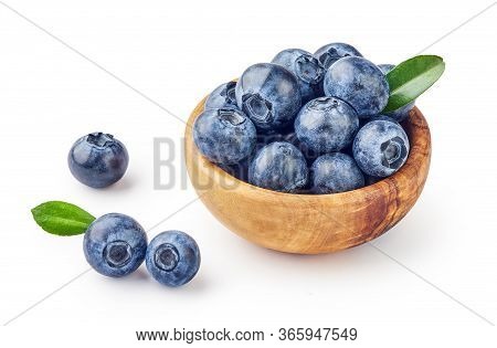Fresh Blueberries With Blueberry Leaves In Wooden Bowl Isolated On White Background.