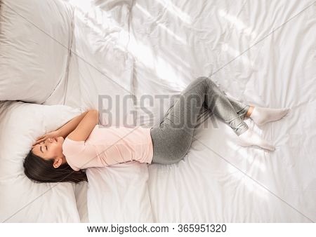 Japanese Girl Sleeping Lying In Bed At Home In The Morning. Healthy Sleep Concept. Above View