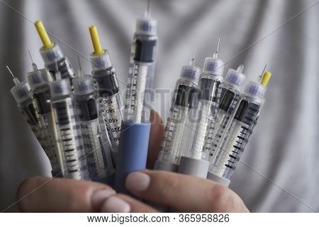 Diabetes Insulin Dependent Concept, Hands With Syringes Pen Injectors With Doses Of Humalog For Subc
