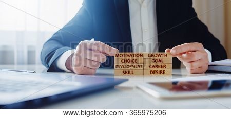 Personal Development Concept. A Man Lays On The Table Wooden Blocks With The Words Motivation, Growt