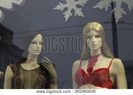 Two Beautiful Girls Mannequin In A Shop Window. Underwear Red And Black Underwear, Long Hair And Mak