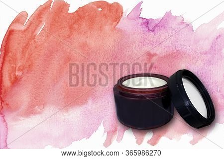 Isolated Face Cream On An Artistic Colorful Background. Photo With Copy Space. Face Cream Open. Face