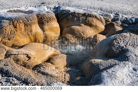 Close-up Of Boiling Water In Shell Spring At Yellowstone Park During Sunny Day