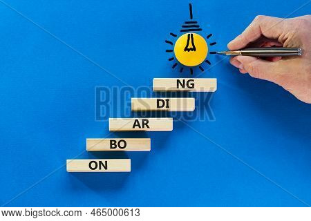 Onboarding Success Symbol. Wooden Blocks With The Word Onboarding. Light Bulb Icon. Businessman Hand