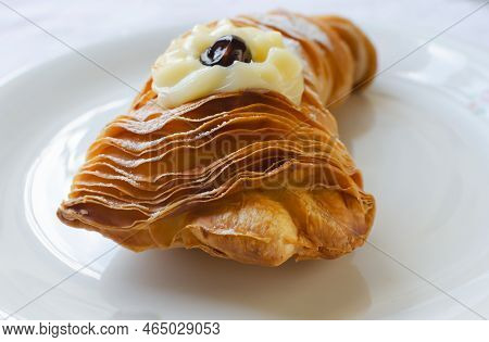 Sfogliatellla Riccia (also Called Lobster Tail In The Us) On A White Plate. The Concept Of Tradition