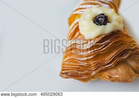 Sfogliatellla Riccia (also Called Lobster Tail In The Us) On A White Plate. The Concept Of Tradition