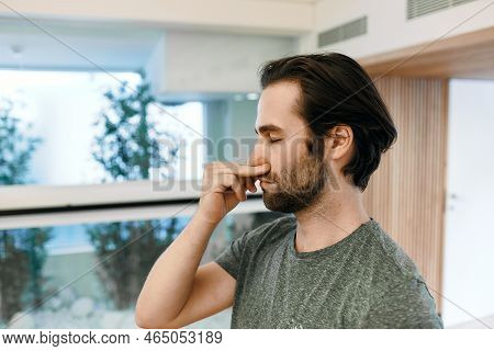 Handsome Man Practicing Yogic Breathing Technique, Pranayama Technique And Alternating Right And Lef