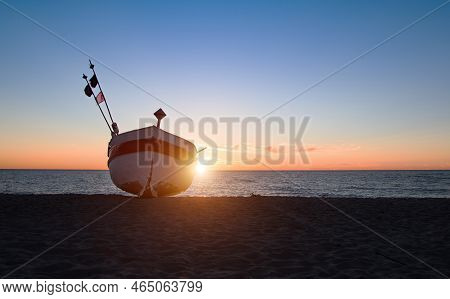 Fishing Boat On The Beach Of The Polish Baltic Coast Near Rewal. Sunset