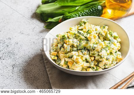 Healthy Salad Of Green Wild Leek, Poached Egg And Cucumber, Close Up. Wild Garlic Salad With Boiled