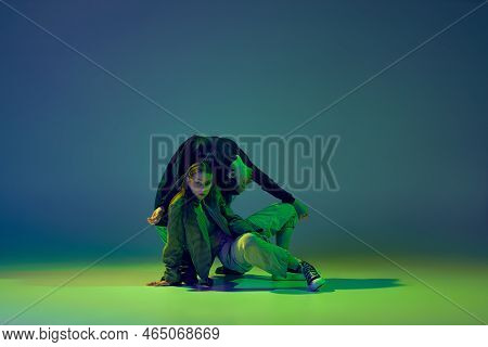 Modern Dance Concept. Energetic Couple Of Two Young Woman Dancing Contemporary Dance On Gradient Blu