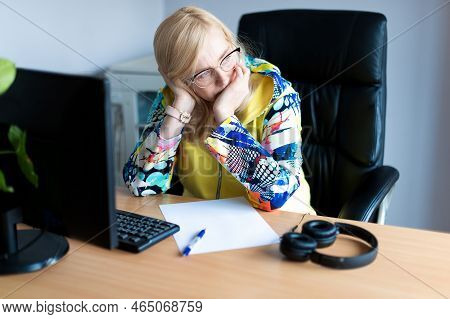 Middle aged tired, stressed and frustrated business woman desperate working at office with computer