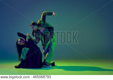 Relationship. Young Stylish Flexible Girls In Modern Attires Dancing Contemp Style Dance Isolated Ov