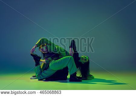 Young Stylish Flexible Girls In Modern Attires Dancing Contemp Style Dance Isolated Over Gradient Bl
