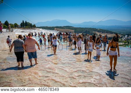 Pamukale, Turkey - September 14, 2022: People On Calcite Cliff Of Pamukkale, White Travertines In Tu