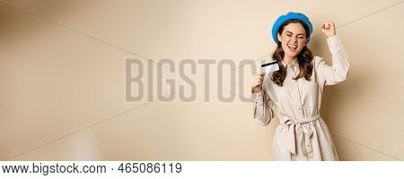 Enthusiastic Young Woman Yearning To Go Shopping, Dancing With Credit Card And Celebrating, Laughing