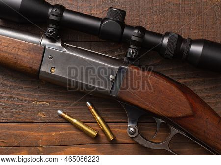Lever-action Hunting Rifle And Bullets On Wood