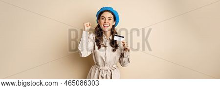 Enthusiastic Young Woman Yearning To Go Shopping, Dancing With Credit Card And Celebrating, Laughing