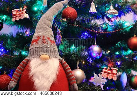 Christmas Gnome Standing On The Background Of The Christmas Tree