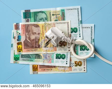 Electric Plug With Knotted Power Cable On Bulgarian Lev Banknotes Over Blue Background. Concept Of R