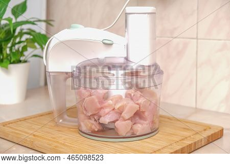 Food Processor With Pieces Chicken Breast. Process Of Cooking Chicken Fillet Dishes. Mince, Grind, K