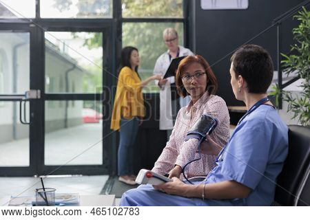 Hospital Nurse Doing Cardiology Exam With Tonometer To Measure Hypertension And Hypotension, Checkin